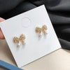 White Pearl Ribbon Bow Tie Crystal Rhinestone Pave Invisible Clip On Earrings